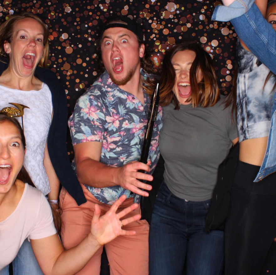 A group posing as terrified taking their picture in the photo booth