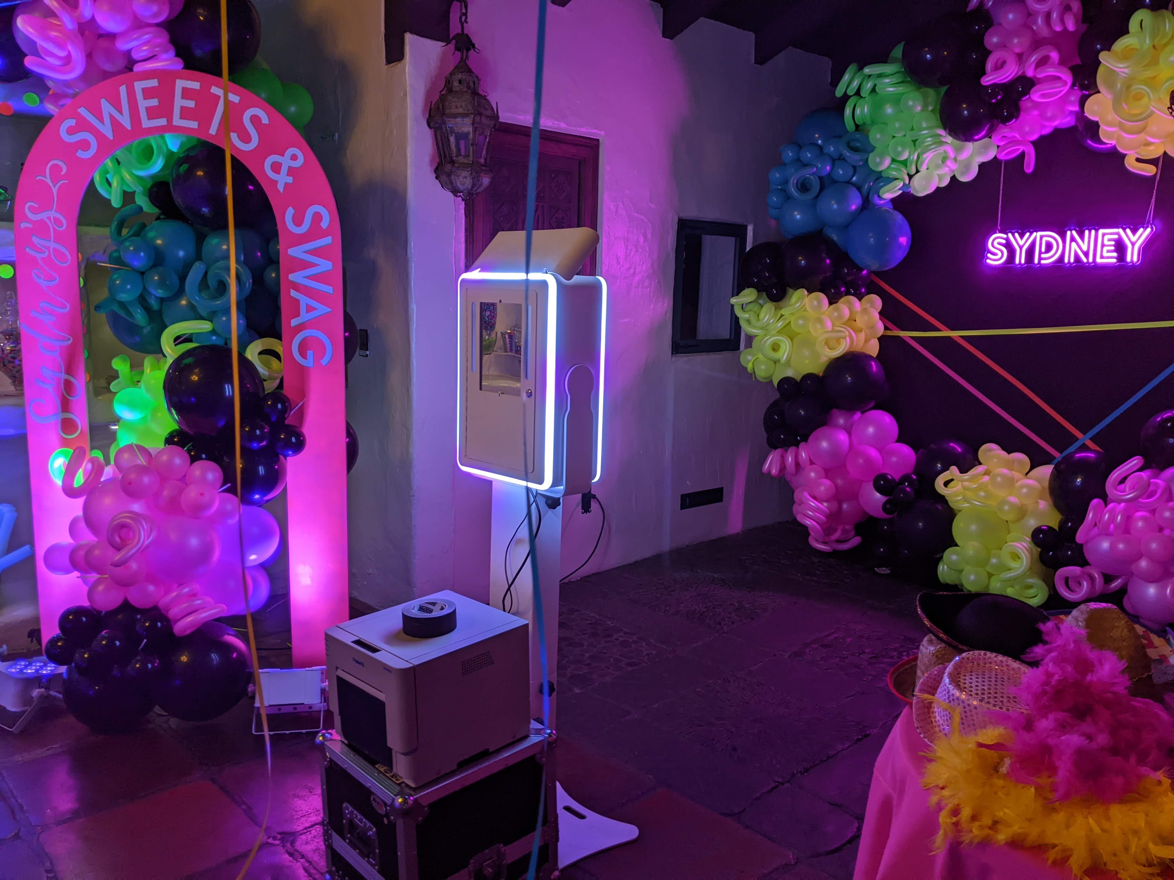 A candy themed photo booth setup with fluorescent lighting